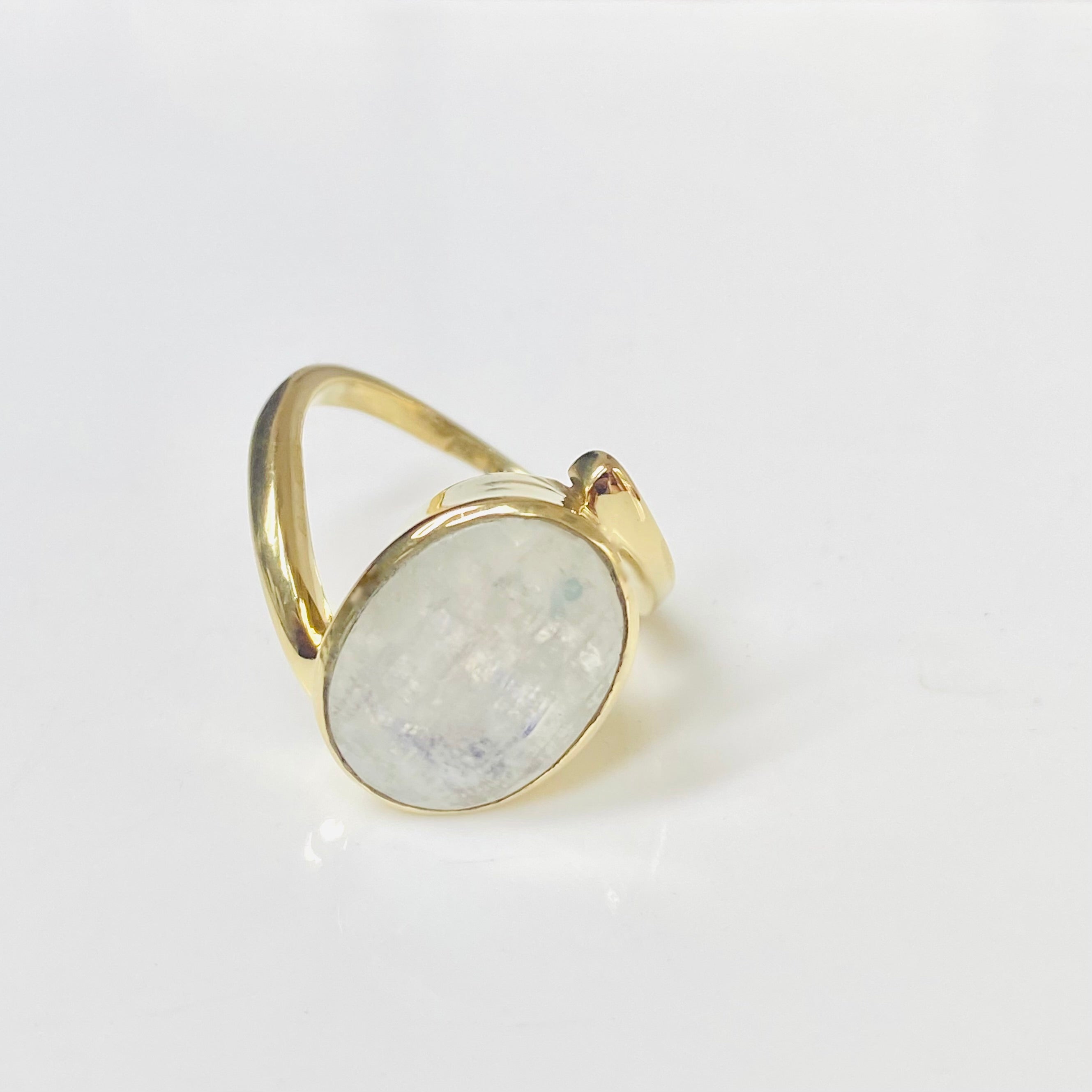 A gold-colored ring with moonstone gemstone