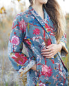 Woman wearing a floral patterned coat in an outdoor setting